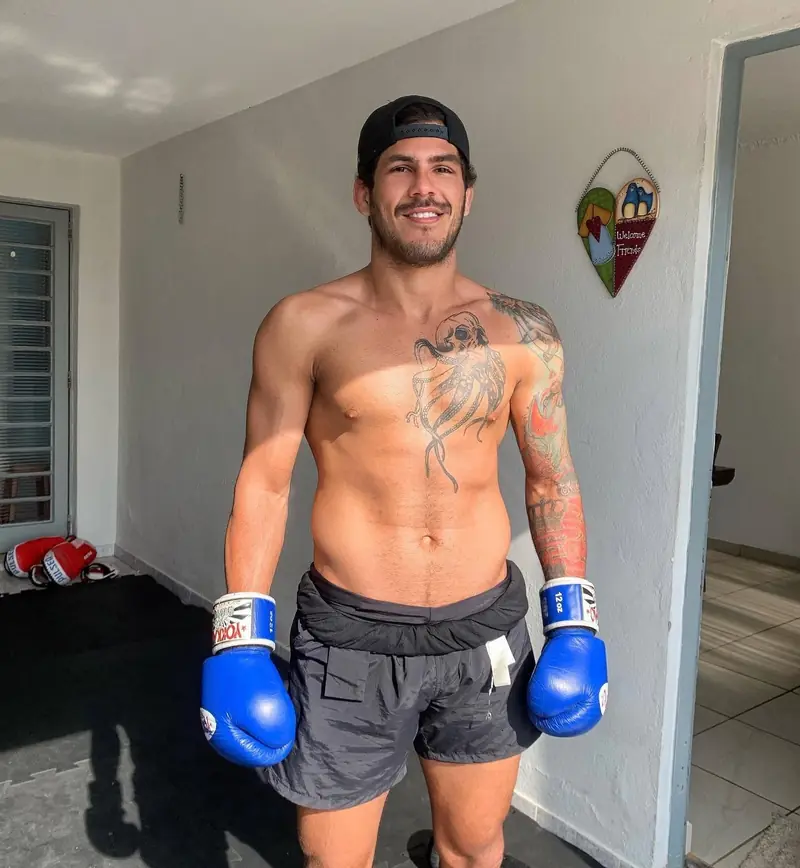 Kevem in blue gloves, smiling after training