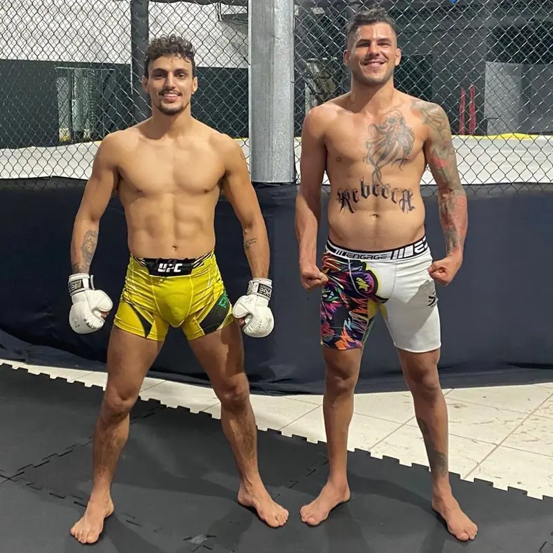 Kevem and a fighter side by side in the training cage