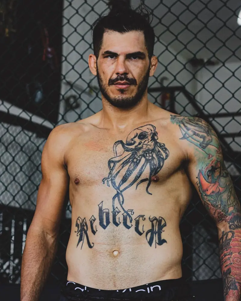 Portrait of Kevem shirtless in the cage