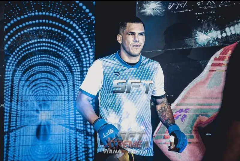Kevem in an SFT shirt in front of an LED wall