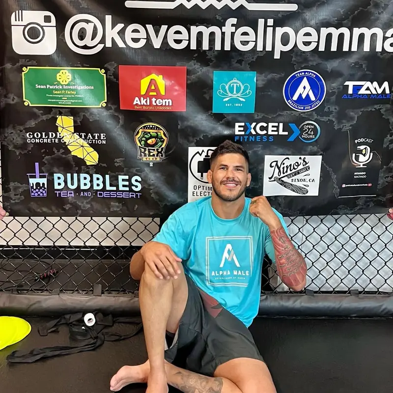 Kevem in the cage in front of his sponsors’ board