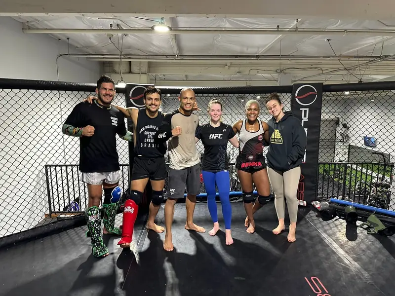 Kevem with the team in the gym cage