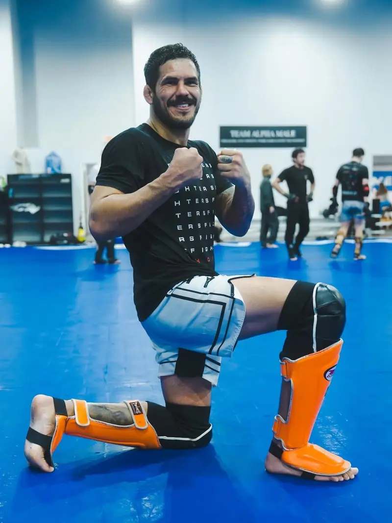Kevem kneeling on the mats in shin guards