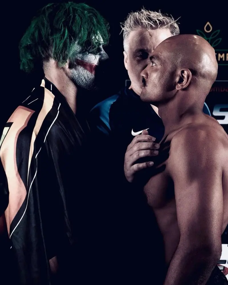 Weigh-in face-off, with the Joker on stage