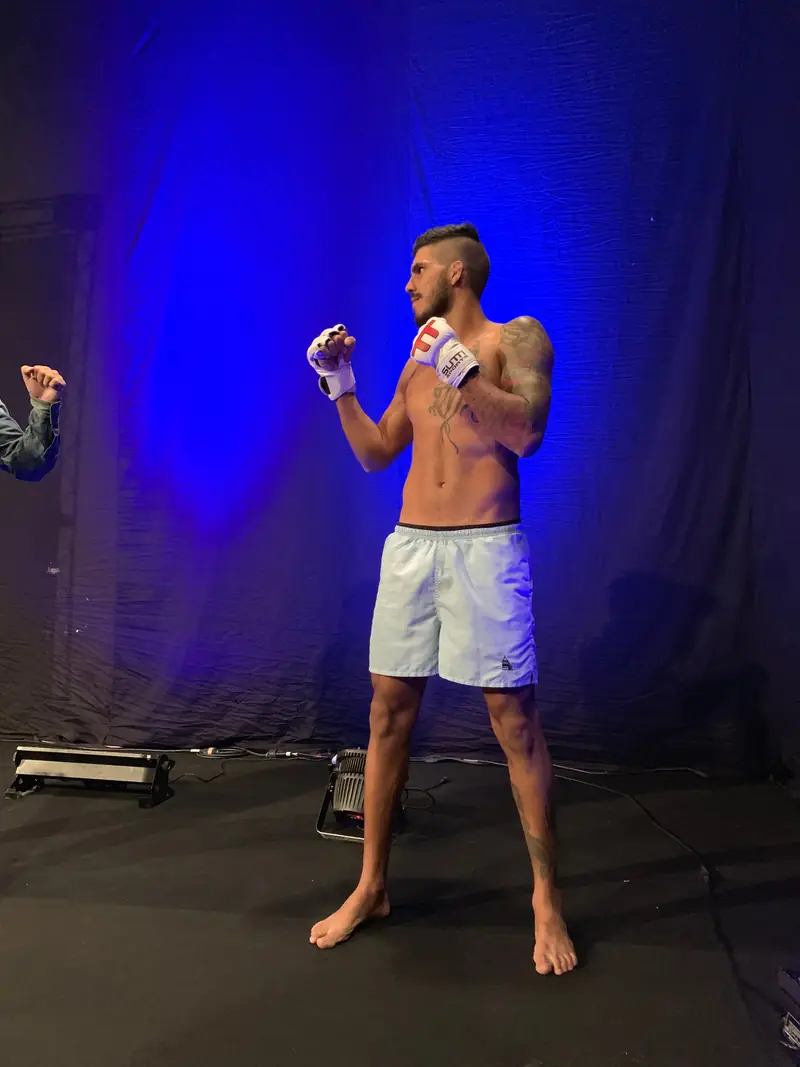 Kevem poses in gloves at the pre-fight shoot