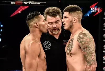 Kevem and his opponent face to face with the referee at SFT